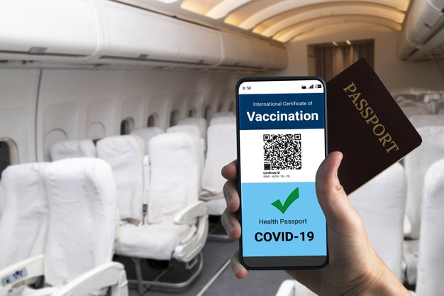 traveler-holds-vaccine-passport-certificate-show-covid-19-vaccination-status_31965-15822